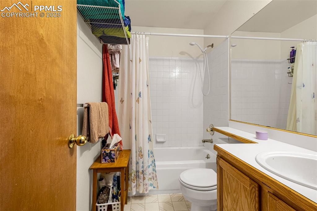 Image 16 of 33: Full bath featuring shower / tub combo, vanity, and tile patterned flooring
