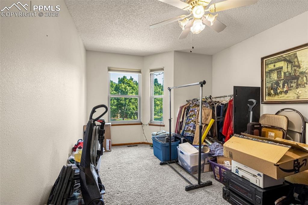 Image 17 of 33: Workout room featuring carpet floors, a textured ceiling, and a ceiling fan
