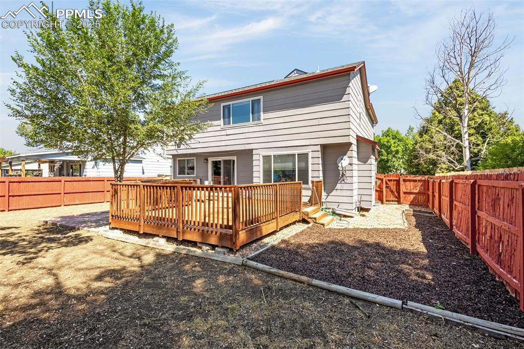 Image 27 of 33: Rear view of property with a fenced backyard and a deck