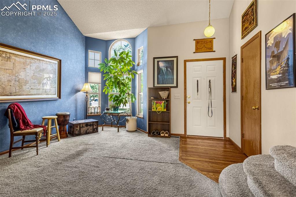 Image 3 of 33: Foyer entrance featuring wood finished floors and a textured ceiling
