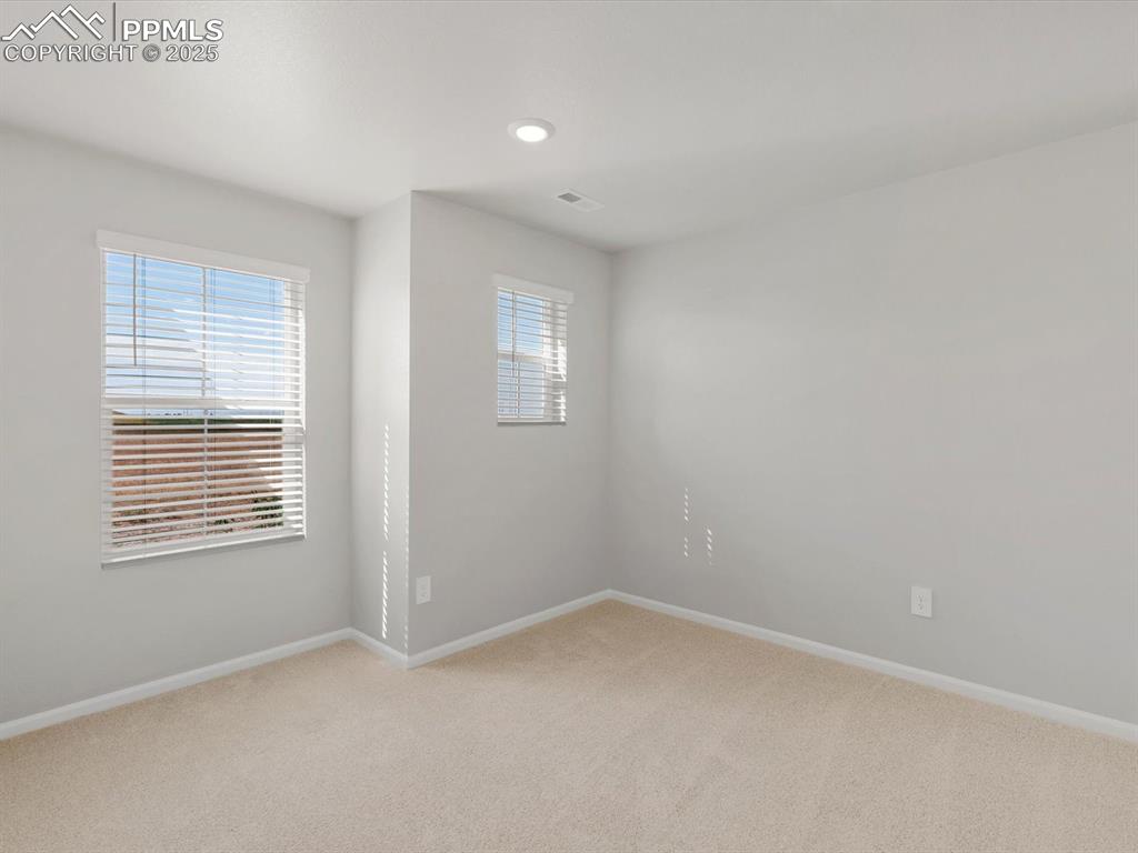 Image 11 of 15: Unfurnished room featuring light colored carpet and recessed lighting