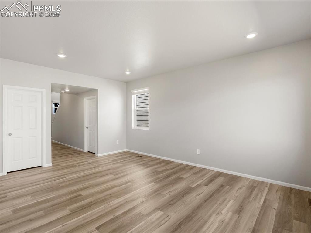 Image 2 of 15: Unfurnished room with light wood finished floors and recessed lighting