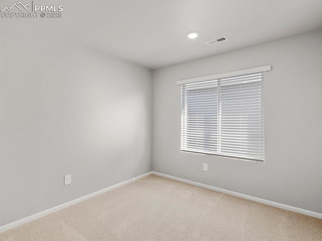 Image 9 of 15: Empty room with carpet floors and recessed lighting