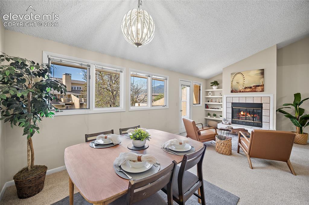 Image 11 of 42: Dining area and living room with beautiful natural light
