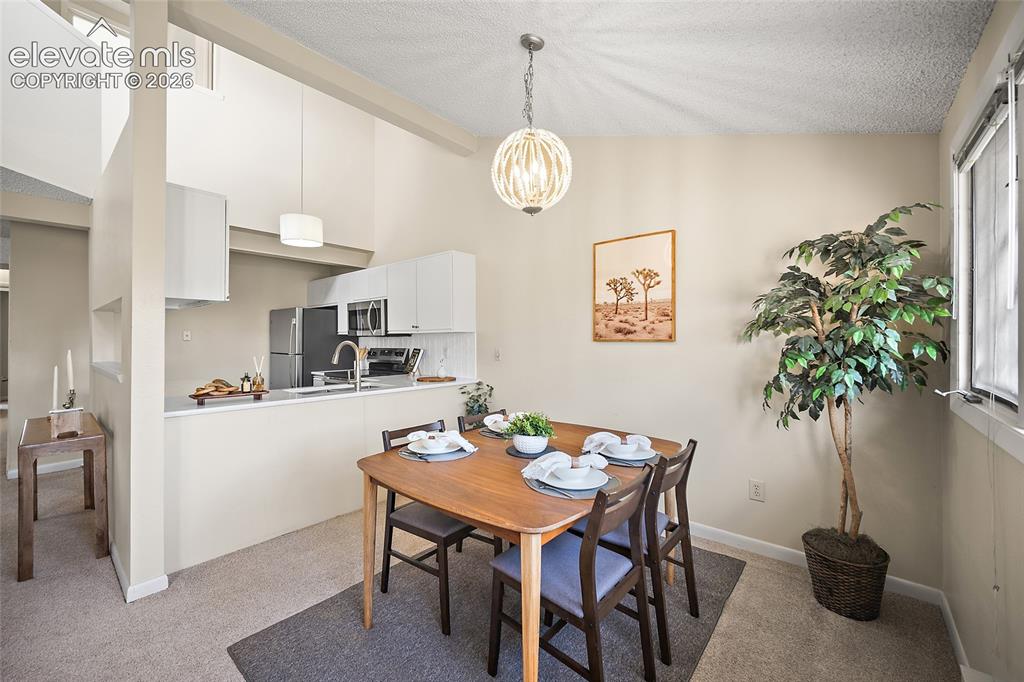 Image 12 of 42: Dining room and open kitchen