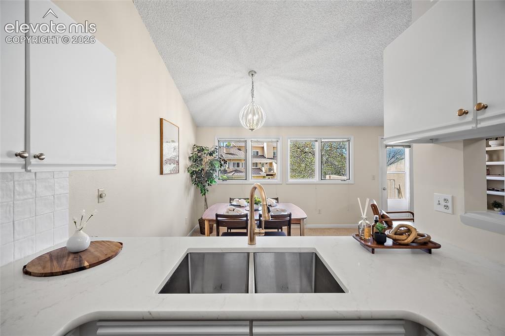 Image 15 of 42: View of kitchen to dining area