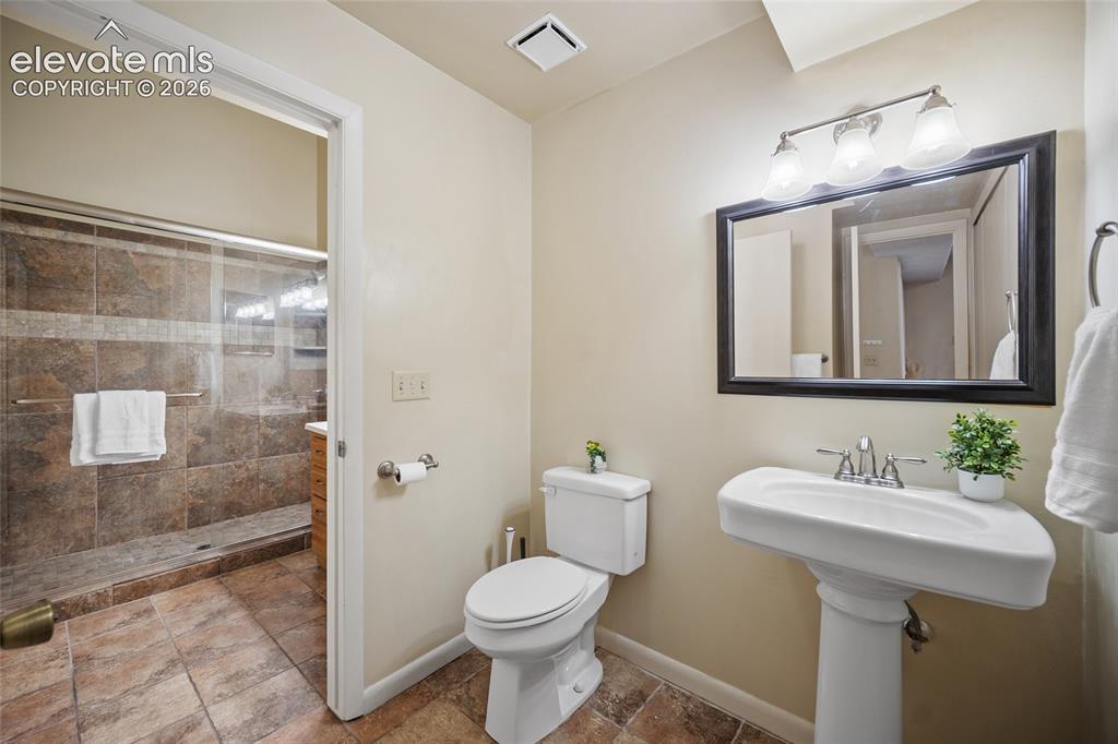 Image 23 of 42: Water closet with entry from primary bath and living room