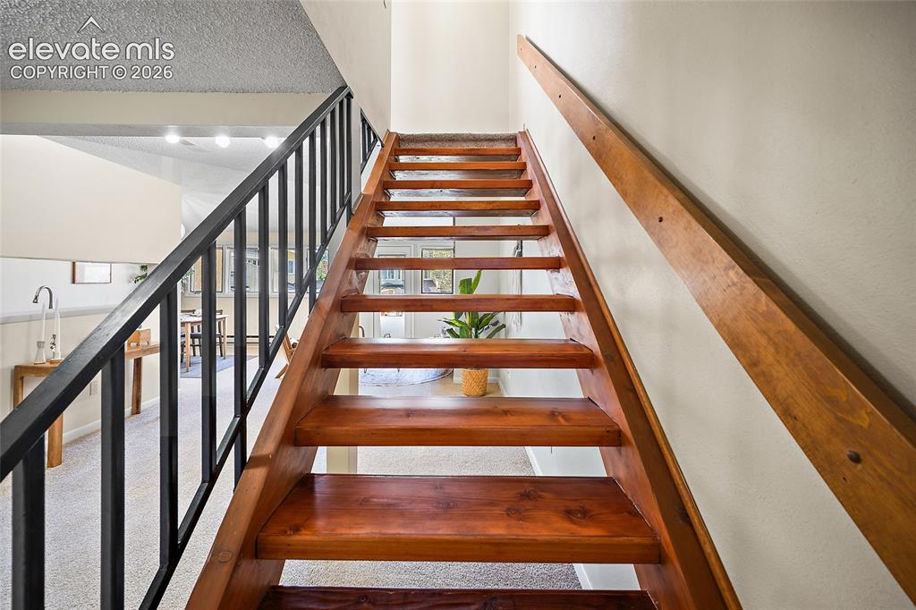 Image 25 of 42: Newly refinished stairs with entry to the loft bedroom