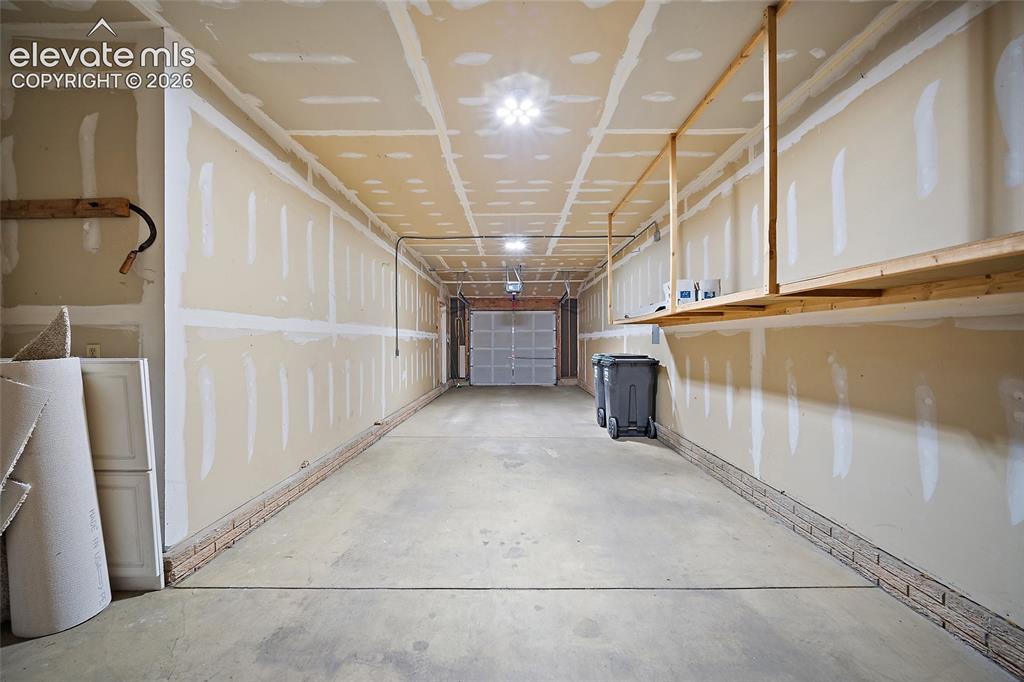 Image 33 of 42: View of large garage from the back to entry