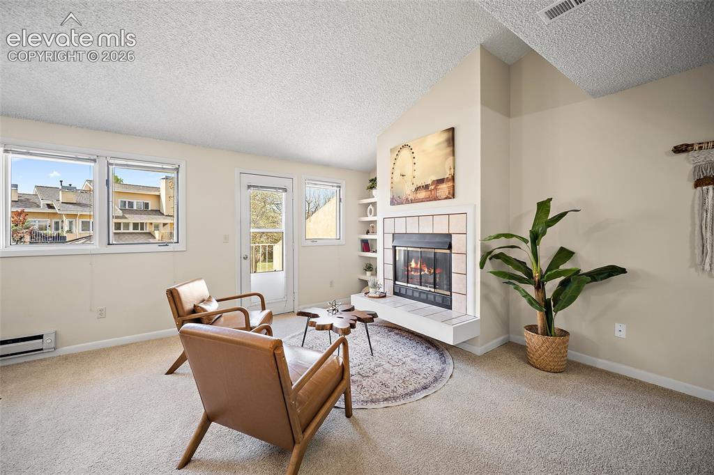 Image 5 of 42: Living room with wood burning fireplace