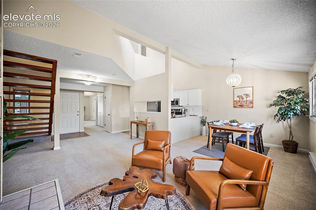 Image 9 of 42: Living room with view to kitchen and entry