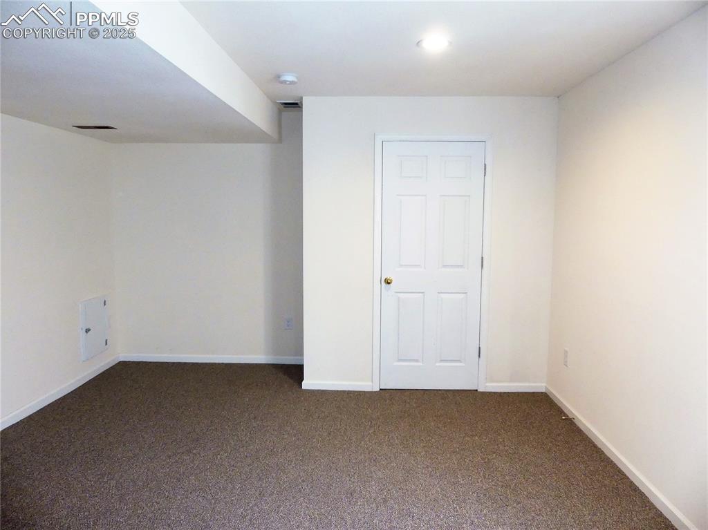 Image 43 of 50: Basement room with carpet floors and recessed lighting