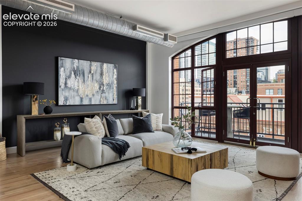 Image 11 of 33: Exposed ductwork, dark accent wall, expansive windows with grid pattern, do