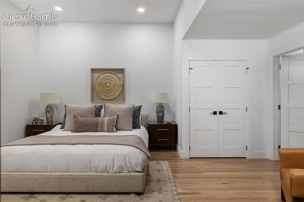 Image 14 of 33: Recessed lighting illuminates the space, featuring white paneled doors with