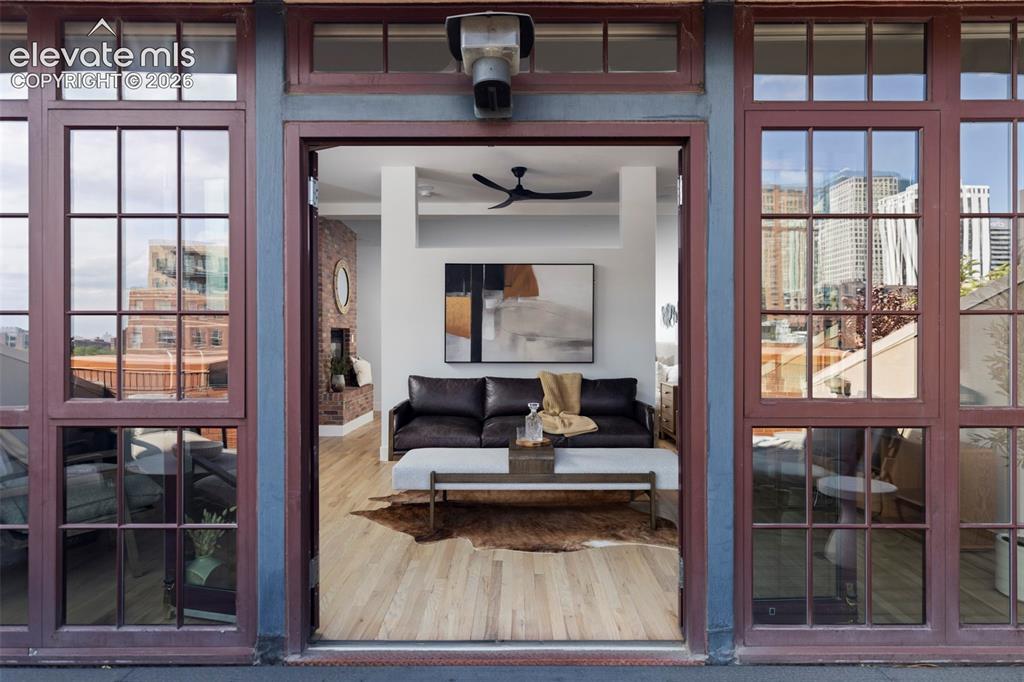 Image 20 of 33: Interior space featuring wood-finish flooring, a ceiling fan, and a partial