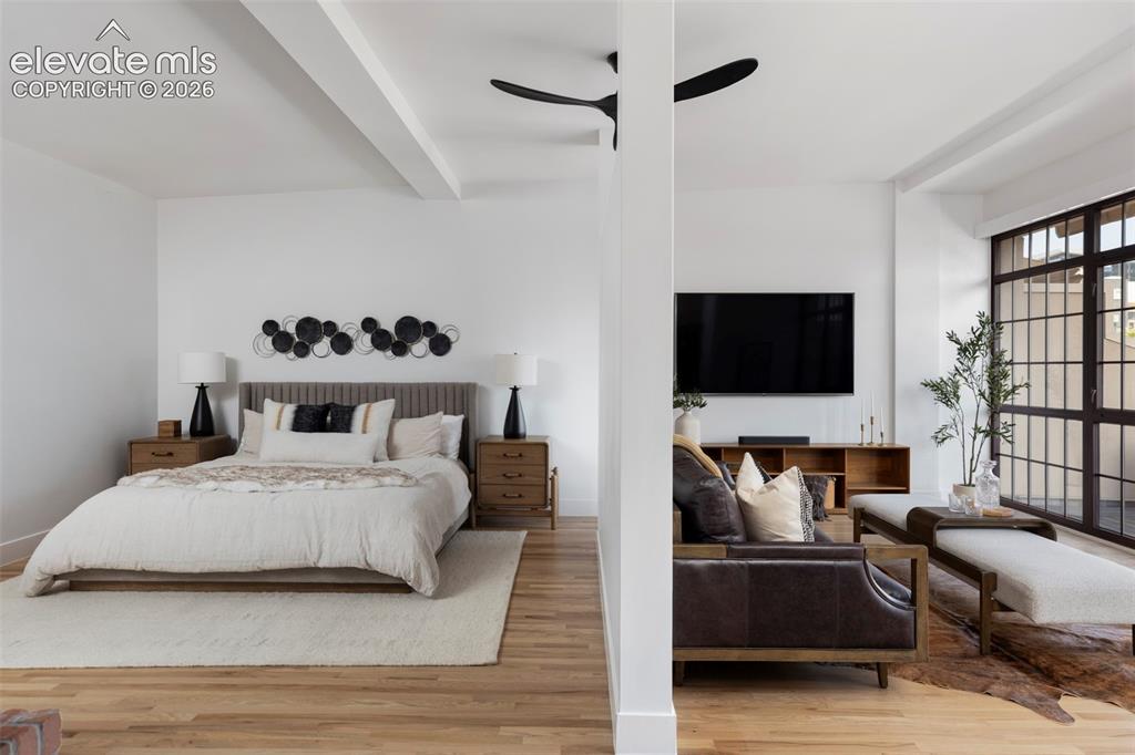 Image 24 of 33: Open-concept layout featuring wide plank wood-finish flooring, exposed stru