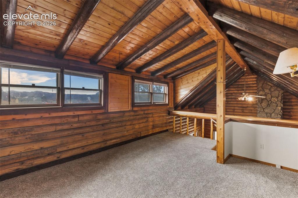 Image 18 of 32: Open loft design overlooks the vaulted main level living area below.