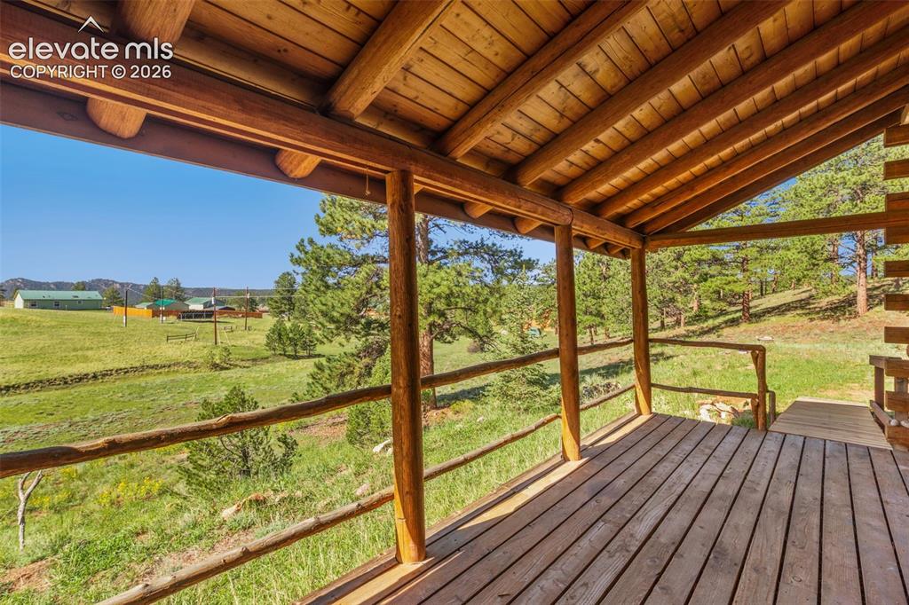 Image 27 of 32: Covered outdoor space offers a place to enjoy the surrounding Colorado land