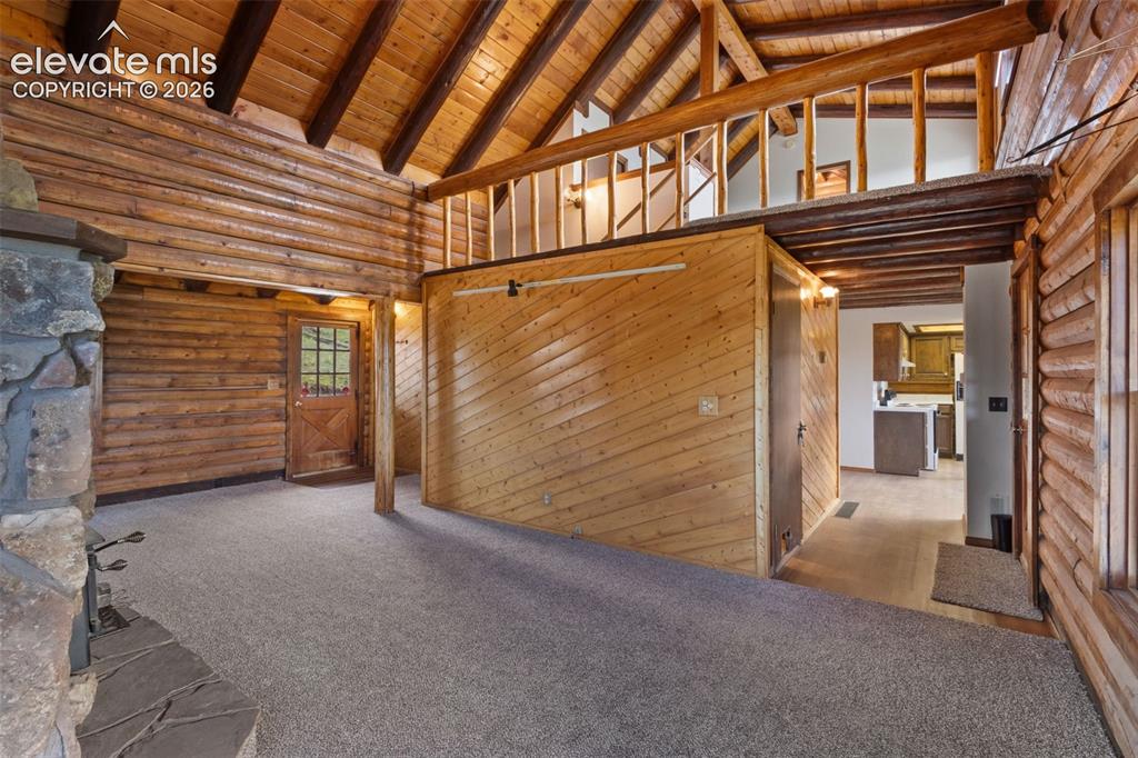 Image 5 of 32: Vaulted ceiling and upper loft overlook add dimension to the main living sp