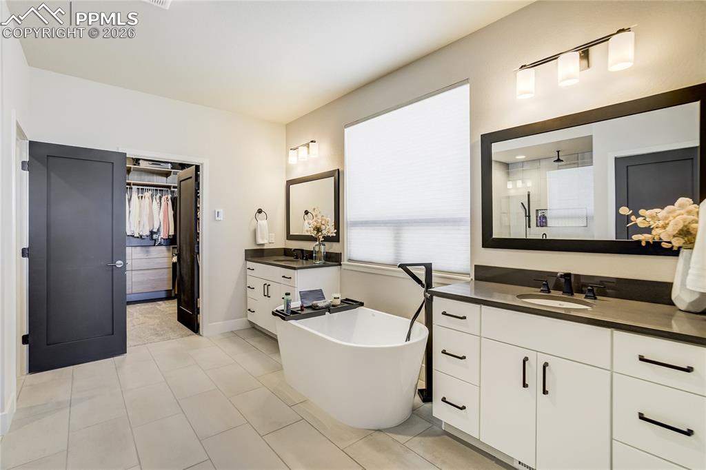 Image 18 of 50: Freestanding soaking tub and filler, three-head shower designed for restora