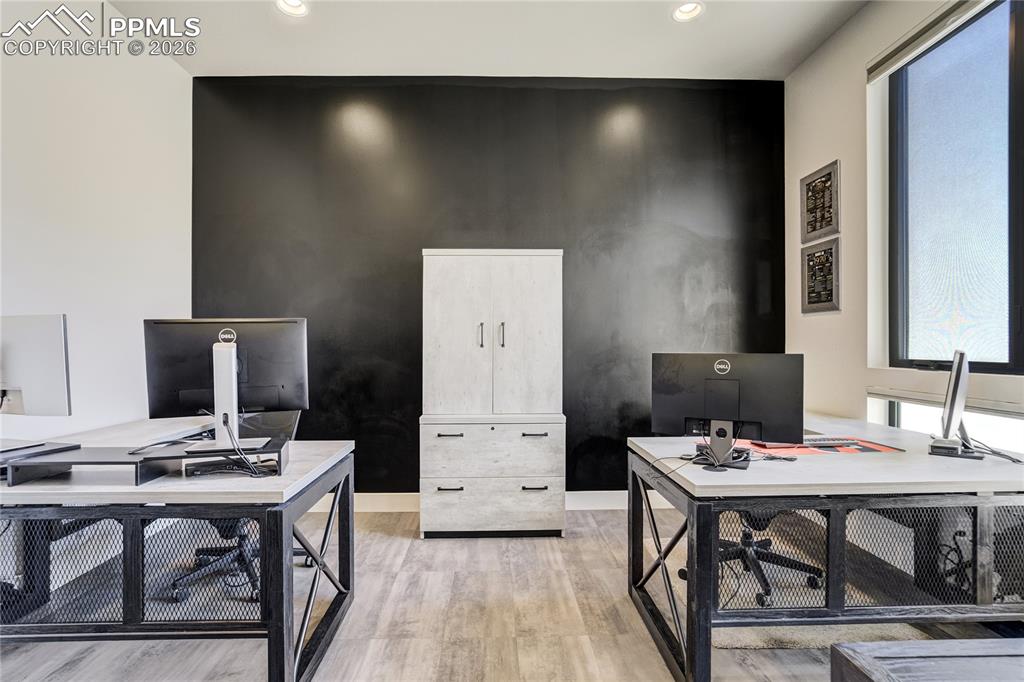 Image 21 of 50: Main-level office with barn door entry and architectural slickwall (chalk w