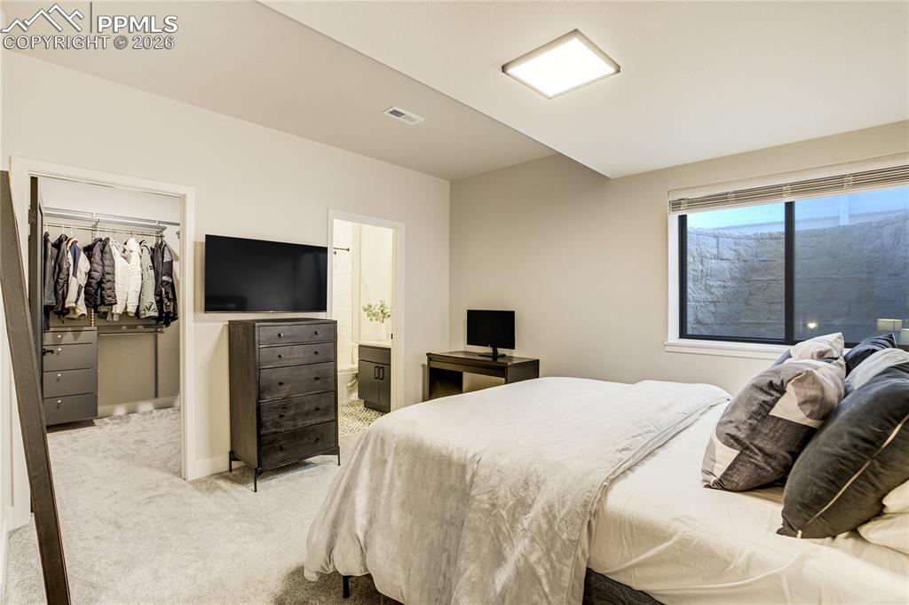 Image 37 of 50: A private lower-level junior suite with its own ensuite bath, offering a co