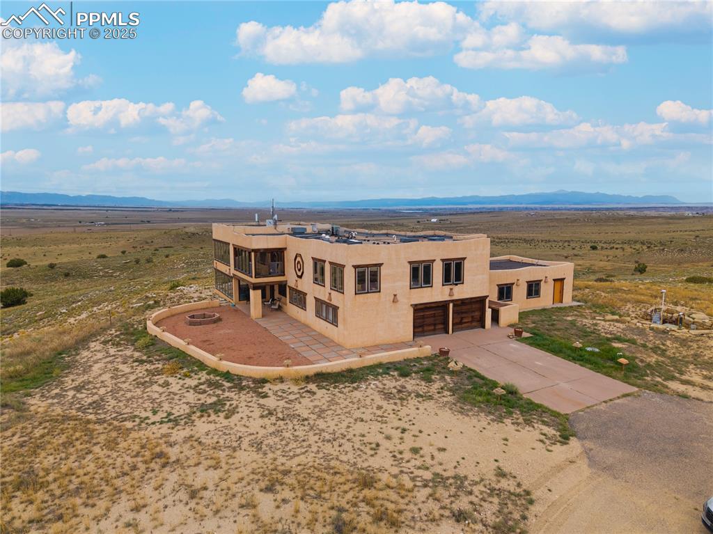 Image 2 of 31: View from above of property with mountains