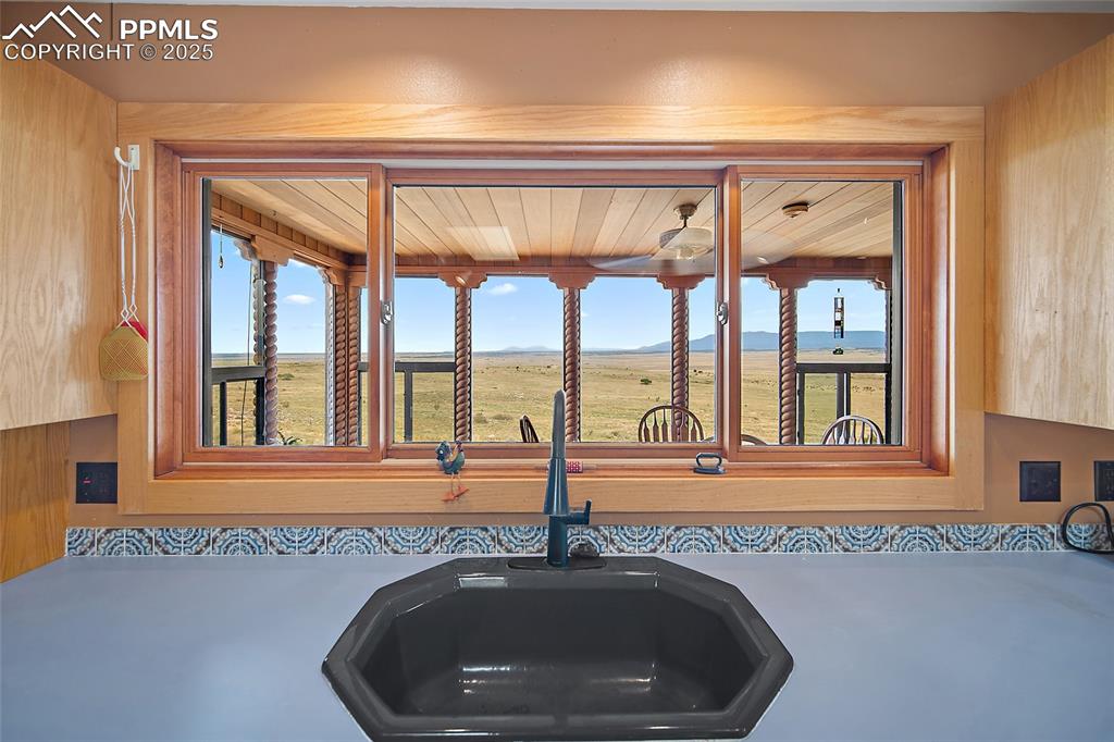 Image 22 of 31: Kitchen view of mountains and light countertops
