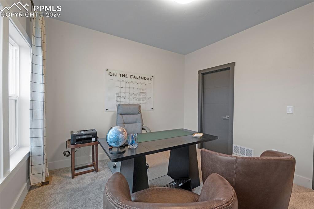 Image 15 of 42: Office space featuring carpet flooring and baseboards