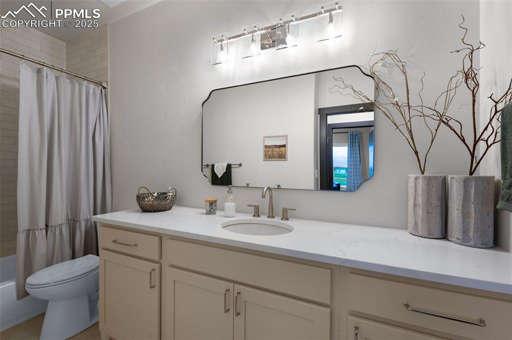 Image 16 of 42: Bathroom featuring shower / tub combo and vanity