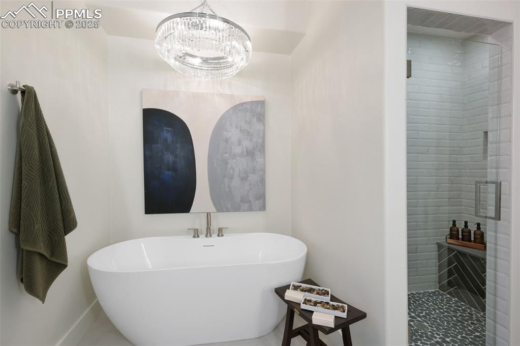 Image 20 of 42: Bathroom with a stall shower and a freestanding bath