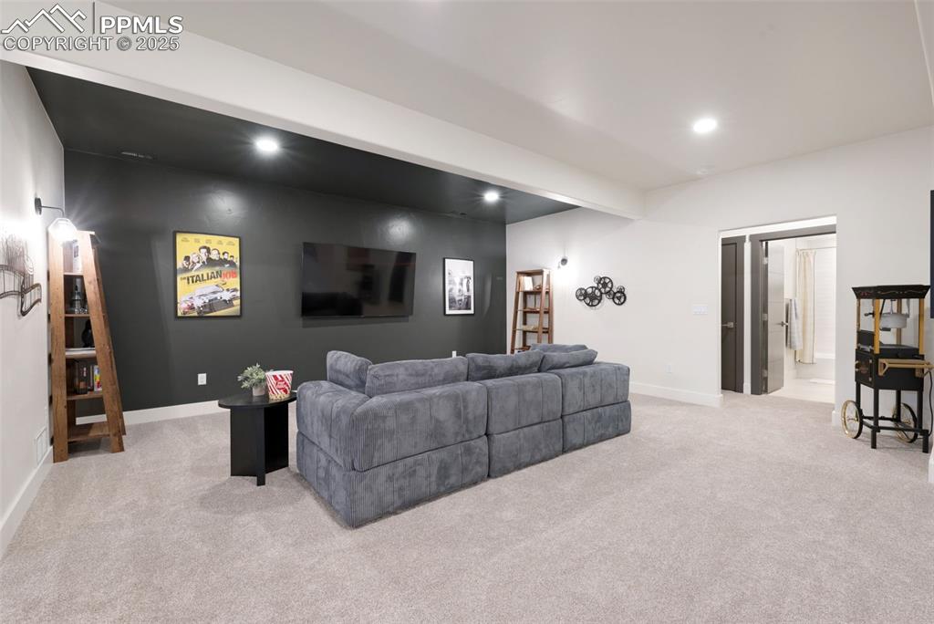 Image 25 of 42: Living area with light carpet, recessed lighting, and beamed ceiling