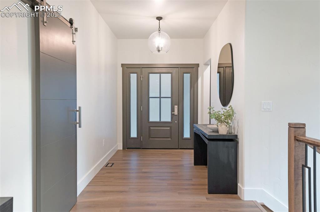 Image 3 of 42: Foyer entrance featuring a barn door and light wood finished floors