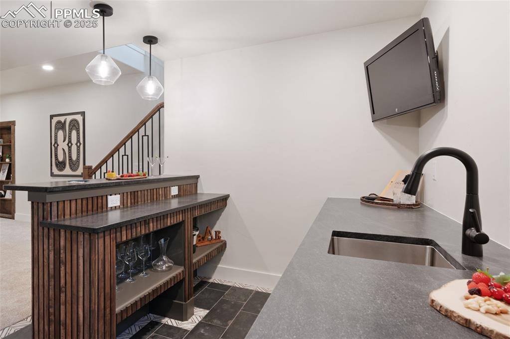 Image 31 of 42: Bar area featuring recessed lighting, dark tile patterned floors, hanging l