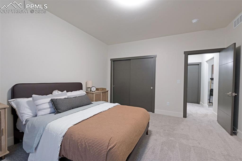 Image 35 of 42: Carpeted bedroom with a closet and baseboards