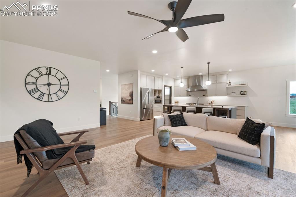 Image 6 of 42: Living area with light wood-style flooring, recessed lighting, and ceiling