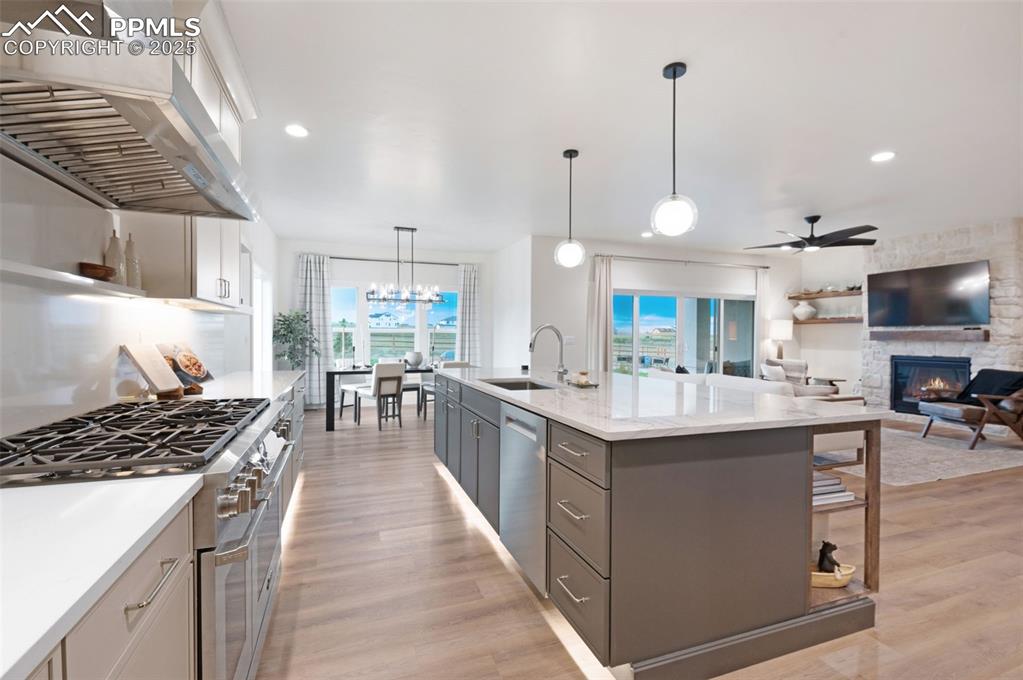 Image 9 of 42: Kitchen with pendant lighting, stainless steel appliances, extractor fan, o
