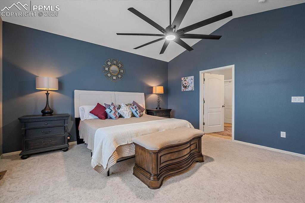 Image 17 of 47: Bedroom with lofted ceiling, carpet floors, and a ceiling fan