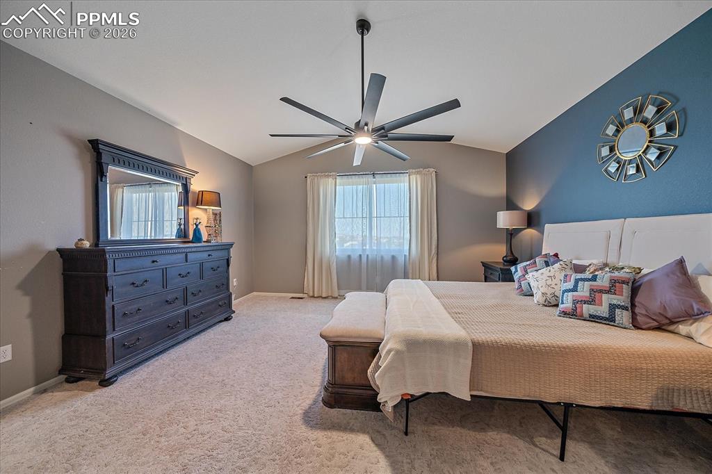 Image 18 of 47: Bedroom with carpet, lofted ceiling, and a ceiling fan
