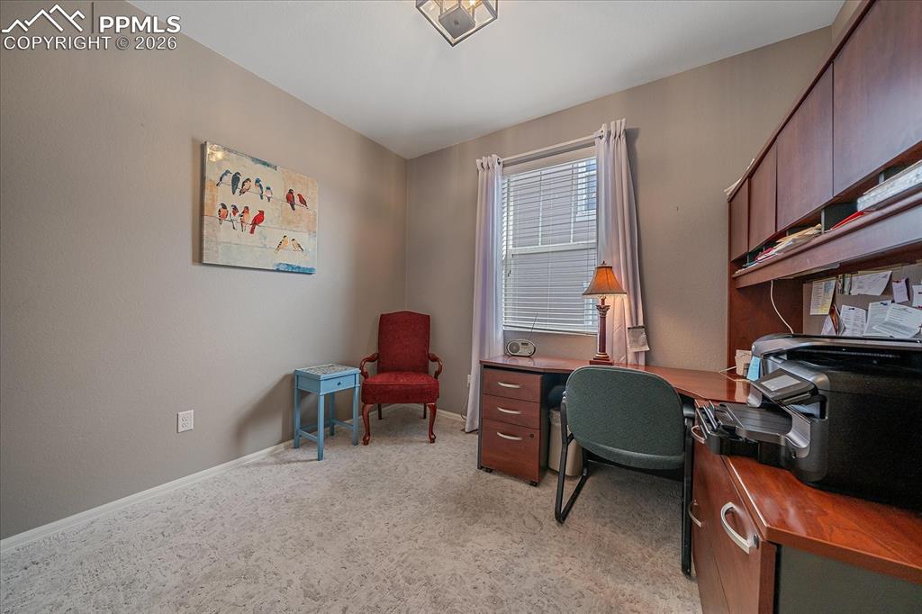 Image 23 of 47: Office area featuring baseboards and light colored carpet