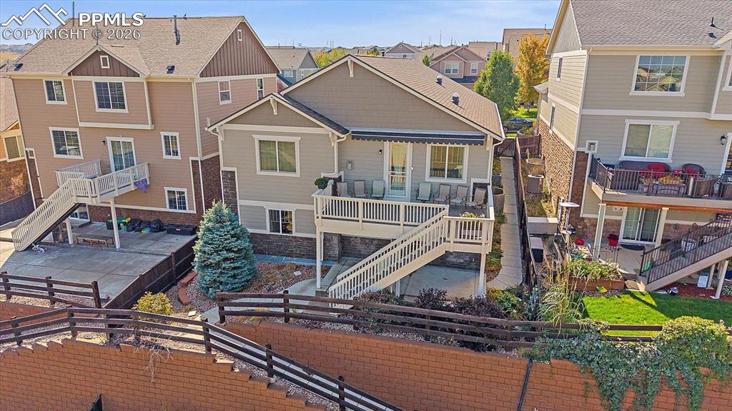 Image 41 of 47: Rear view of house featuring stairway, a residential view, a fenced backyar