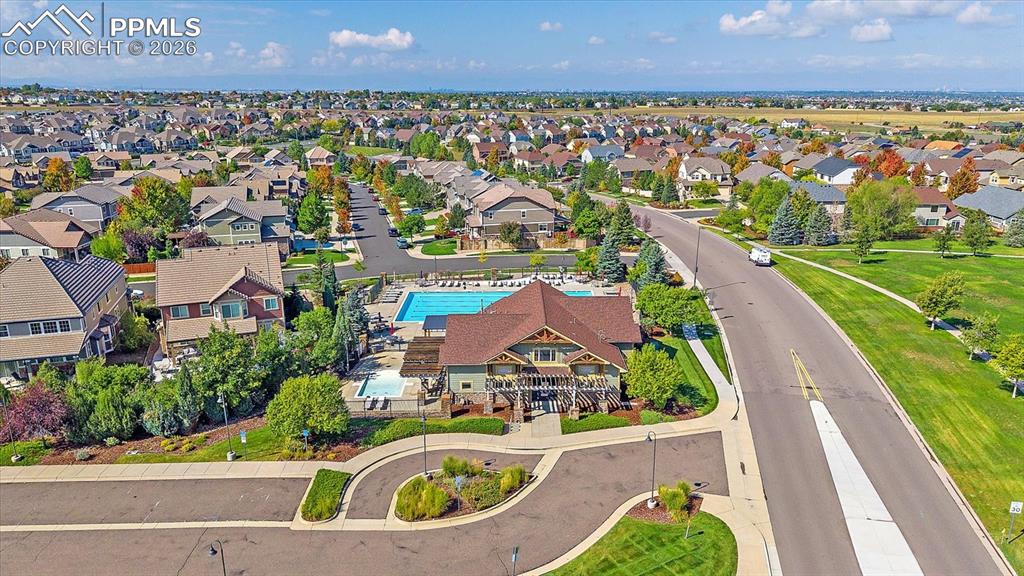 Image 43 of 47: Aerial perspective of suburban area featuring a pool area