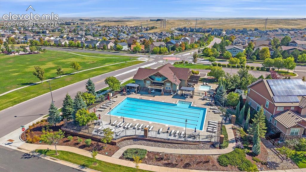 Image 48 of 50: Aerial perspective of suburban area with a pool area