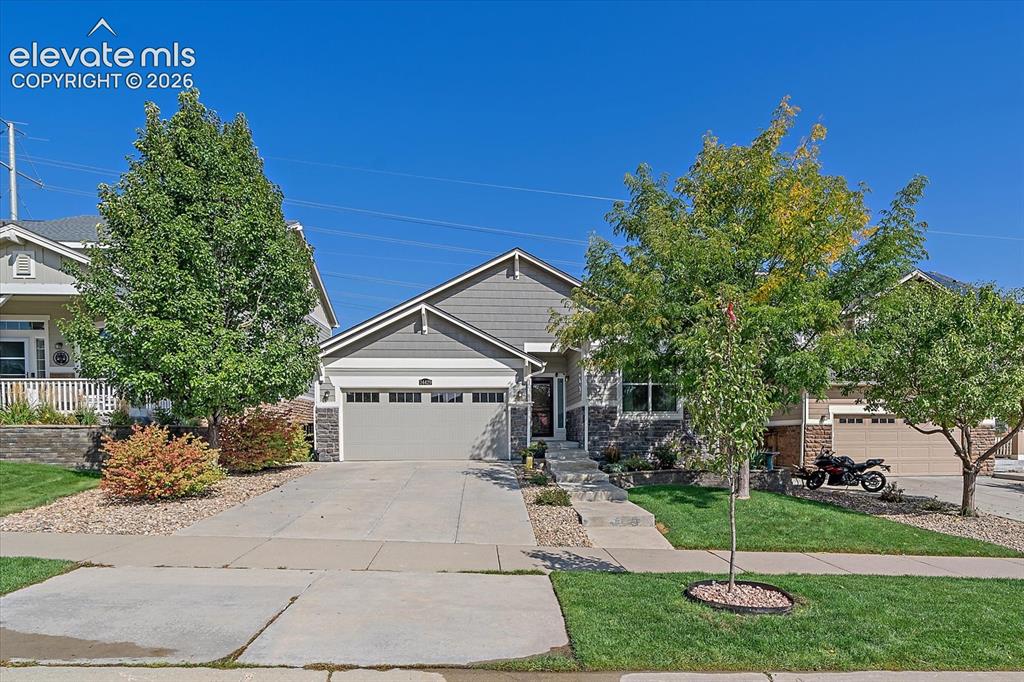 Image 50 of 50: View of front of home with a front yard, a garage, concrete driveway, and s