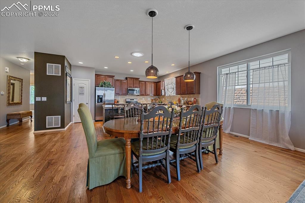 Image 7 of 47: Dining area featuring light wood-style floors and recessed lighting