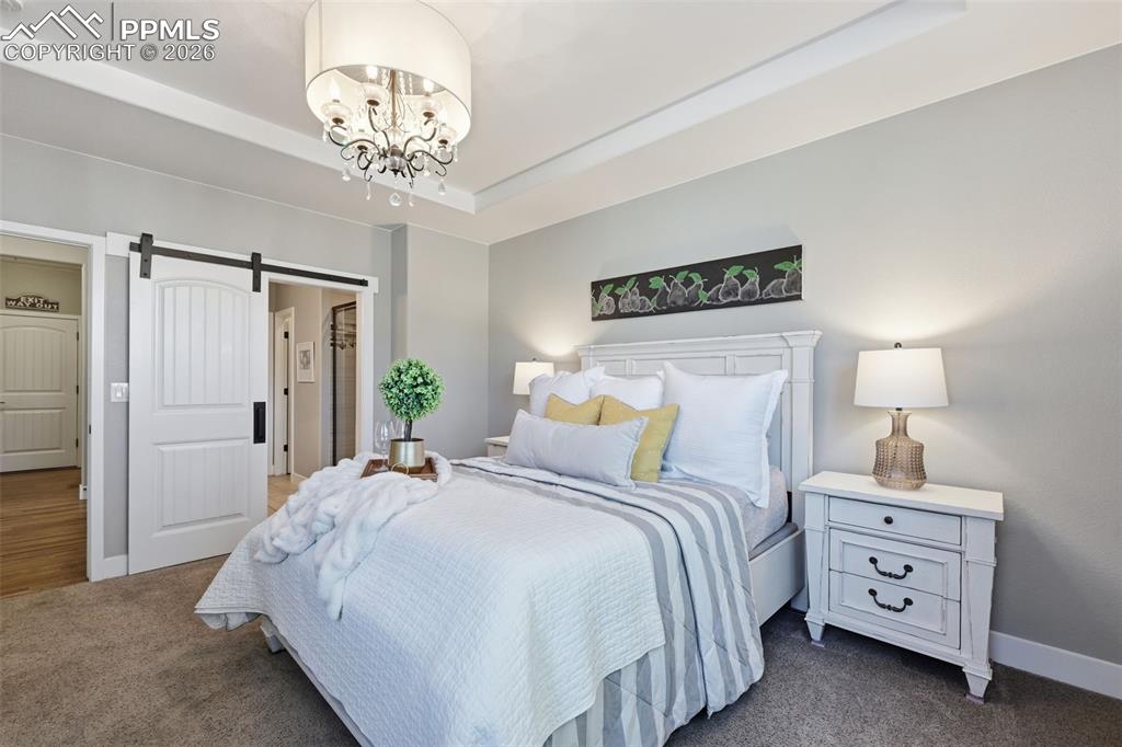 Image 17 of 40: Custom chandelier and barn door in the master bedroom!