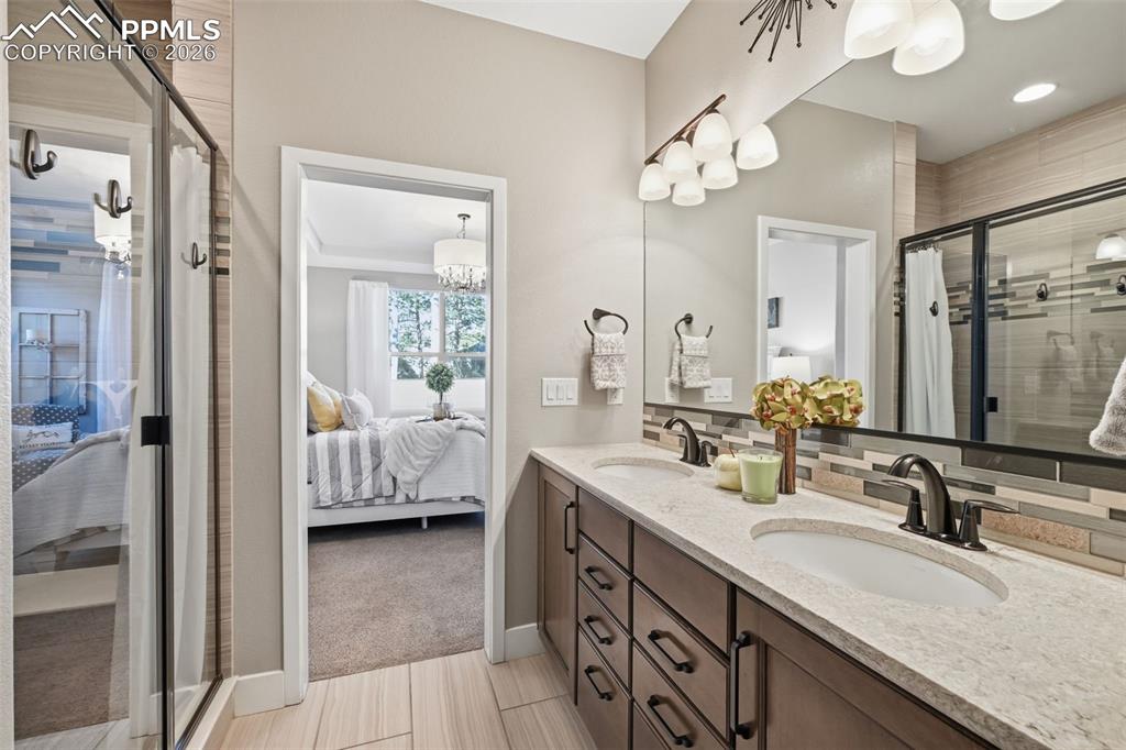 Image 19 of 40: Large shower and plenty of drawers in the spa like master bath!
