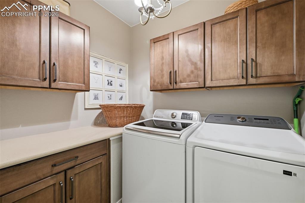 Image 20 of 40: Large laundry room with extra cabinets!