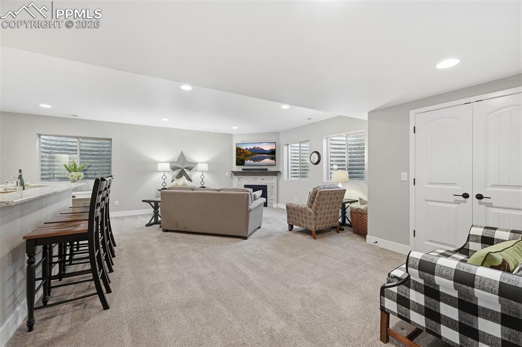 Image 25 of 40: Great entertaining space in the basement with corner fireplace!