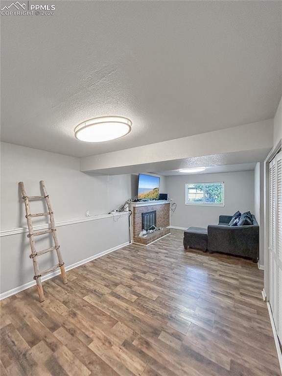 Image 17 of 28: Living Room; Spacious lower-level living area with wood-style flooring, neu